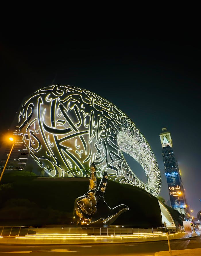 Illuminated Museum of the Future in Dubai at night showcasing futuristic architecture.